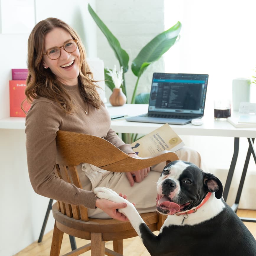 MacKenzie, founder and psychiatric nurse practitioner at Reverie, doing 'shake' with Dottie the Therapy Dog